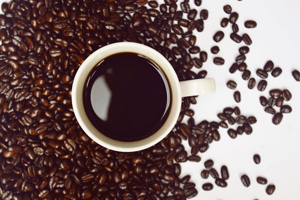 brain healthy cup of black coffee and coffee beans sitting on table